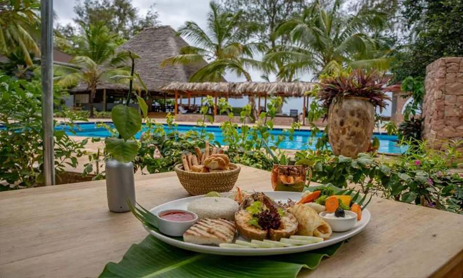Dining by the pool at Michamvi